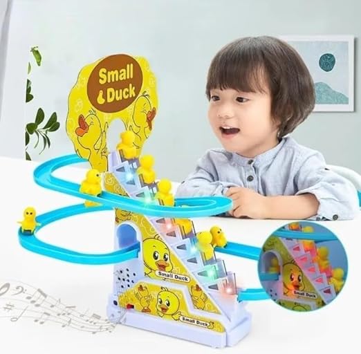 Toddler watching yellow ducks climb the spiral staircase track