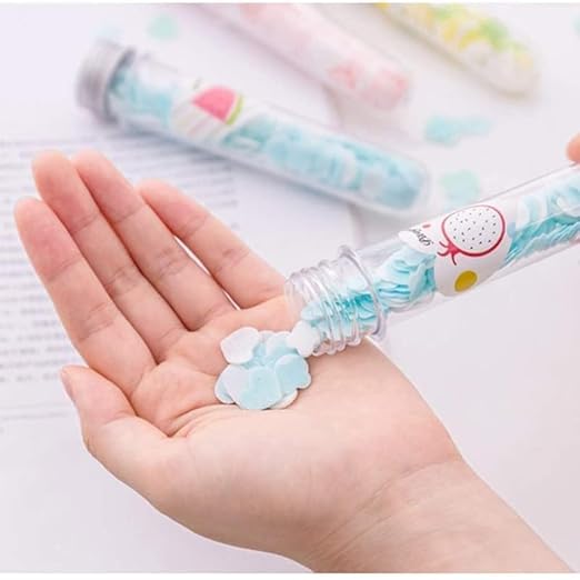 Hand holding soap paper sheets from a fruit-scented tube